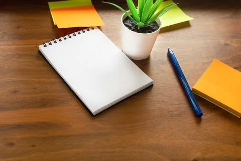 Workplace concept. The flower, notebook and stickers are located on the surfa Stock Photos