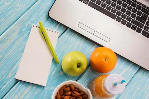 Workplace Desk with laptop, computer, notebook, pen, marker. Useful Smoothie  Stock Photos