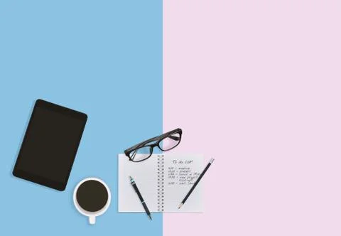 Workplace desktop in pastel with notebook with notes, pen pencils, tablet Stock Photos