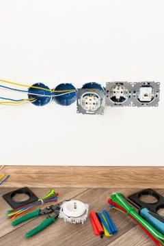 Workplace electrician. the process of installing sockets in the apartment Stock Photos