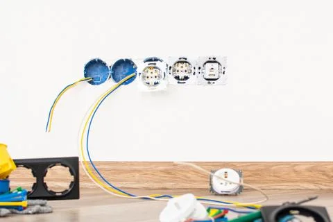 Workplace electrician. the process of installing sockets in the apartment Stock Photos