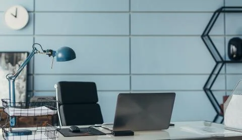 Workplace in empty office. Table with laptop. Stock Photos