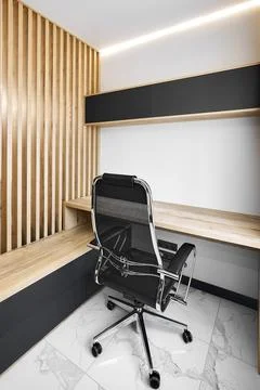 Workplace with empty wooden table and gamer chair in office Stock Photos