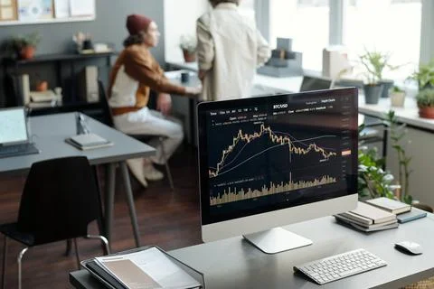 Workplace of financial analyst with graphic data on screen of computer Stock Photos