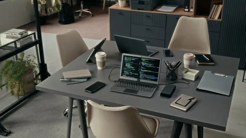Workplace of IT Team with Two Grey Desks Pushed Together and Set Up with Devices Stock Footage 329609315
