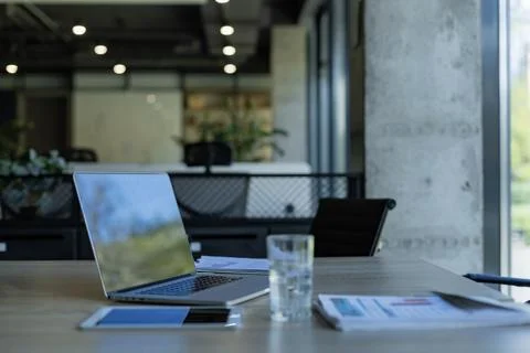 Workplace with laptop and documents, comfortable work table in office Foto stock