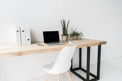 Workplace with laptop computer and folders in modern office Stock Photos
