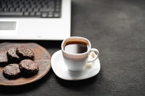 Workplace with laptop computer, coffee and treats Stock Photos