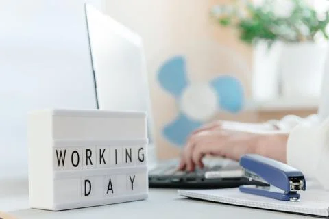 Workplace with a laptop, hands of a man, notepad on a white background Photos