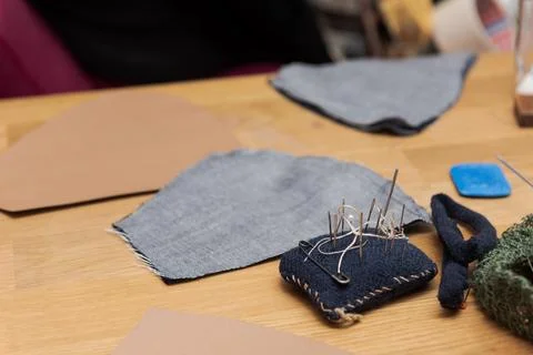 Workplace with a master template made of fabric and a pincushion for making p Stock-Fotos