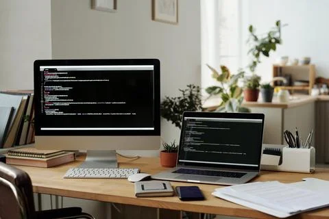 Workplace of modern IT programmer with desktop computer and laptop Foto stock