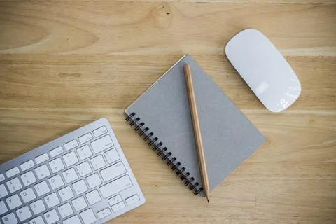 Workplace with notebook and keyboard, mouse on wooden table Stock Photos