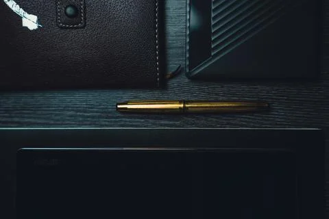Workplace. Notebook with pen and tablet on a wooden table. Strict style Stock Photos
