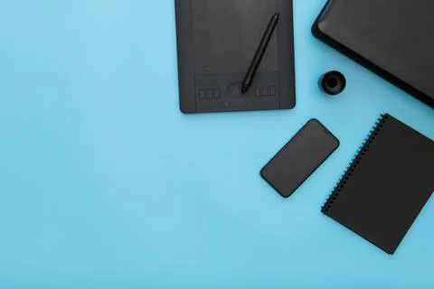 Workplace with notebook, pen graphics tablet, keyboard, smartphone, mouse pad Foto stock