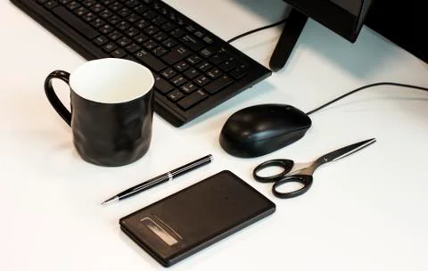 Workplace in the office: a computer, pen, scissors, keyboard, and calculator. Stock Photos