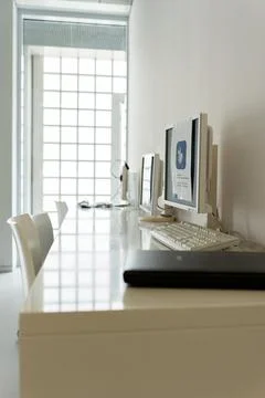 Workplace in the office. There are computers and a scanner on the table. Stock Photos