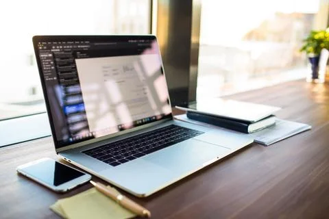 Workplace with open pc laptop computer lying on a desktop near working tools  Stock Photos