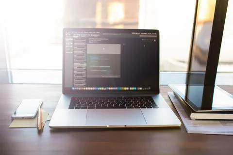 Workplace with open pc laptop computer with web site and programs on screen l Stock Photos