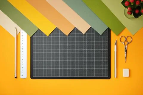 Workplace for paper art projects. Colored paper, cutting mat, pencil, knife,  Stock Photos
