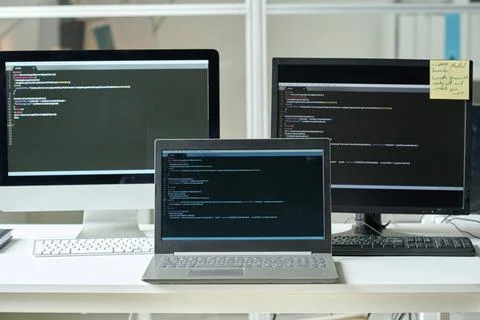 Workplace of programmer with computers with codes Stock Photos
