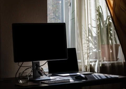 Workplace of a programmer or office worker, computer, monitor, window light Stock Photos