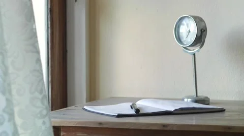 Workplace with table notebook, pen, clock Stock Footage 56333755