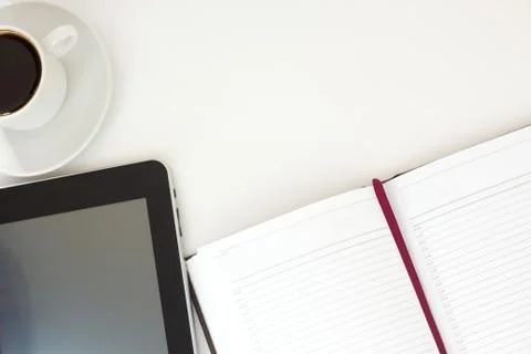 Workplace, tablet pc and coffee on white table with copy space. Stock Photos