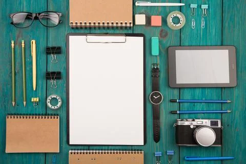 Workplace with tablet pc, camera, watch and other office supply Stock Photos