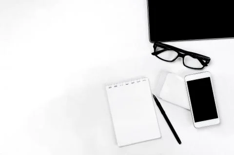 Workplace with tablet, smartphone, pen, notepad and glasses. Фото