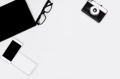 Workplace with tablet, smartphone, pen, notepad and glasses. Stockfoto's