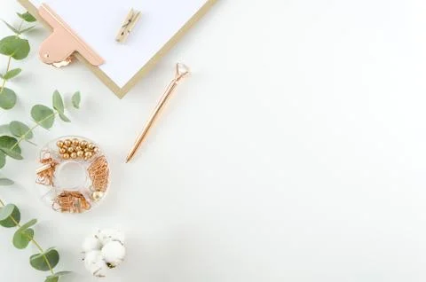 Workplace top view office tools and clipboard with cotton flowers and eucalyptus Stock Photos
