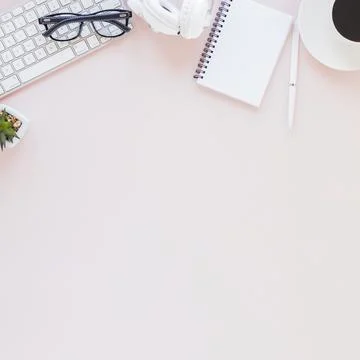 Workplace with various gadgets notebook coffee cup pink background. High quality Stock Photos