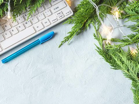 Workplace winter background with keyboard on gray background with branches Stock Photos