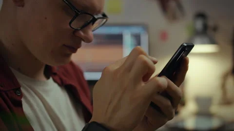 Workplace. A young student optimizes code for smartphones in a home office. Stock Footage 281105602