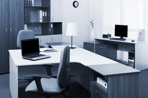 Workplaces with computers in modern office Stock Photos