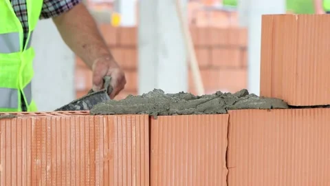 Works with building bricks at construction site Stock Footage 208562659