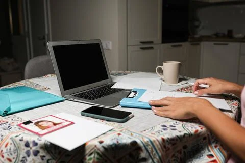 Works at the computer on the table near the kitchen Stock Photos