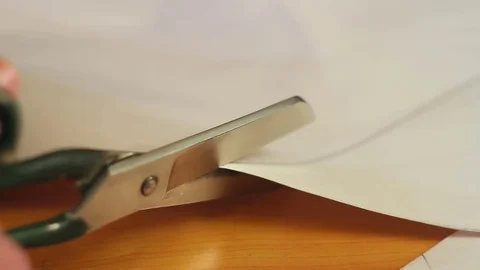 Works cutter. Close-up of a hand with scissors cuts the templates before the cut Stock Footage 81695499