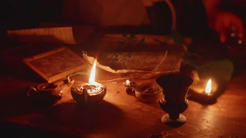 Workshop of an alchemist who is studying at the table full of papyrus, bottl Stock-Footage 148257258
