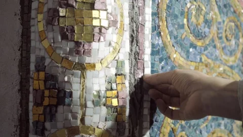 Workshop artist fingers insert small red square mosaic Stock Footage 146254748