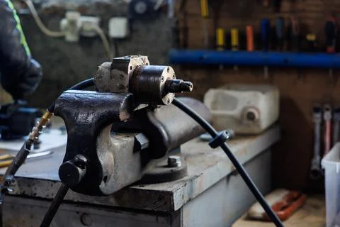 Workshop bench vise with pneumatic component in afternoon light Stock Photos