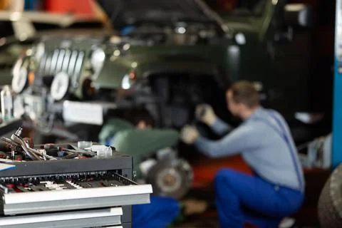 Workshop for car repair with table with different tools in garage Stock Photos