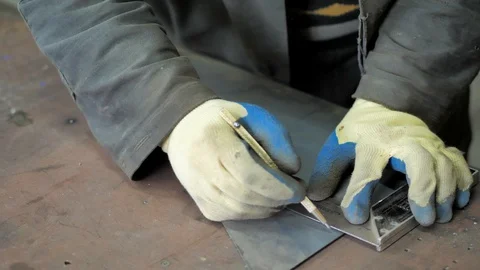 In the workshop. Close-up. The man measures with a ruler and draws a detail Stock Footage 128986244