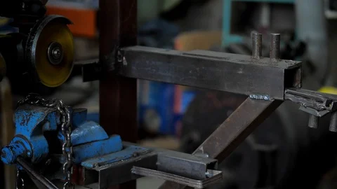 In the workshop. Close-up.The man saws the chain into parts using a circular saw Stock Footage 128998131