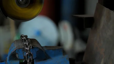 In the workshop. Close-up.The man saws the chain into parts using a circular saw Stock Footage 128998184