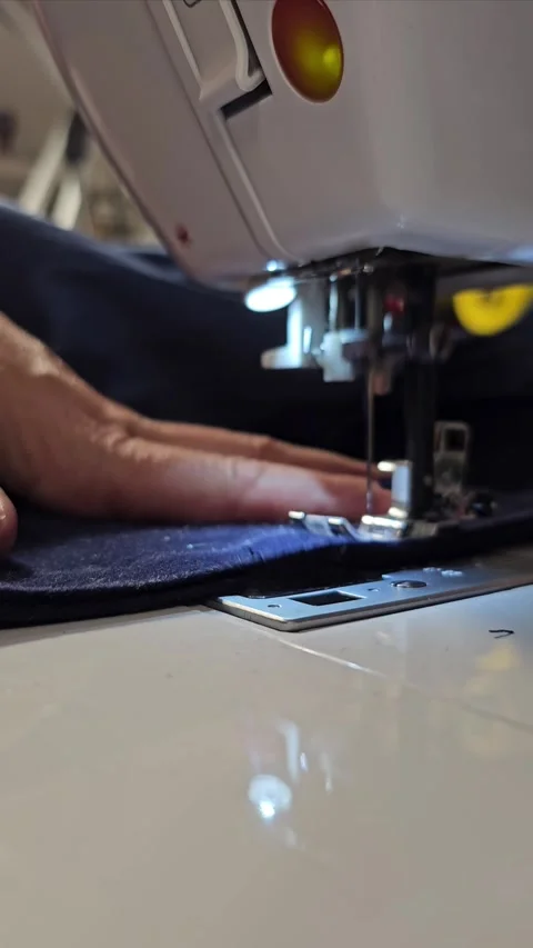 Workshop Close up of the process of sewing fabric on a white sewing machine-a Stock Footage 306609536