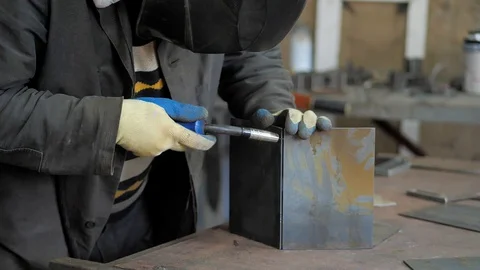 In the workshop. Close-up. Slow motion. Welding performed by skilled welder Stock Footage 128998138