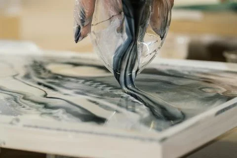 At the workshop on creating fluid art from a plastic cup, black and white resin  Stock Photos