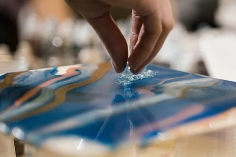 At the workshop on creating fluid art transparent crystals are poured onto the  Stock Photos