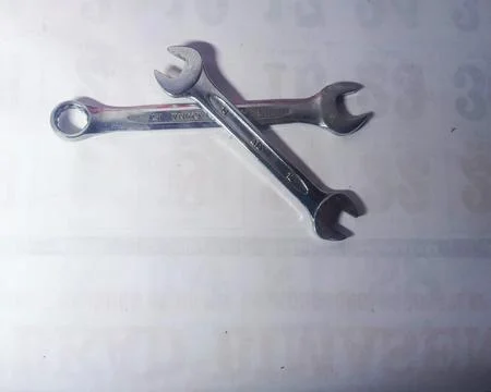 Workshop equipment such as silver colored keys are on the floor. Stock Photos